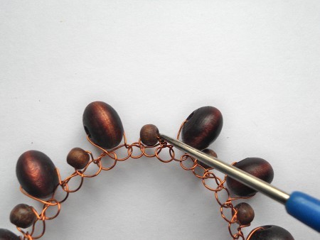 Tucking in the wire end into the bangle.