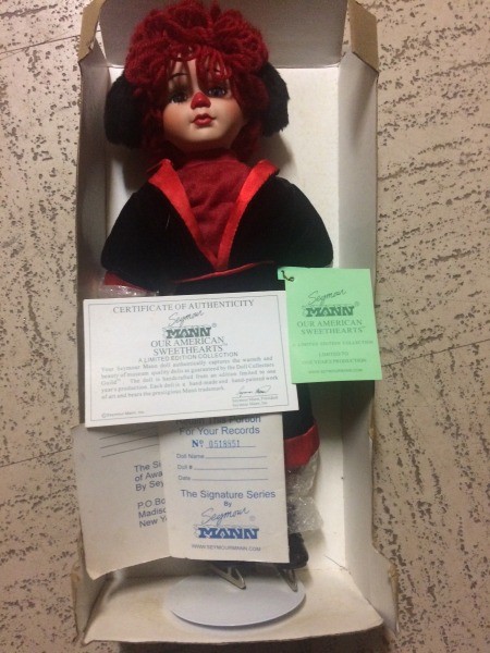 A doll in a cardboard box.