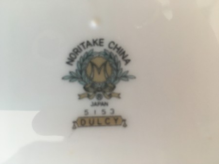 The marking on the bottom of a set of china.