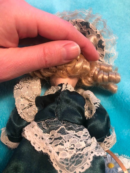 The back of the neck of a porcelain doll.