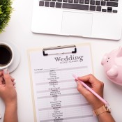 A wedding budget list on a clipboard.