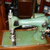 An old green colored sewing machine.