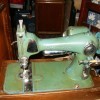 An old green colored sewing machine.