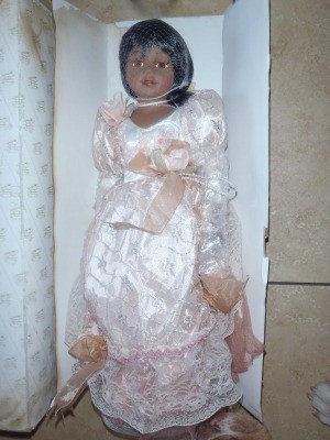 A doll with dark hair and skin, wearing pink.