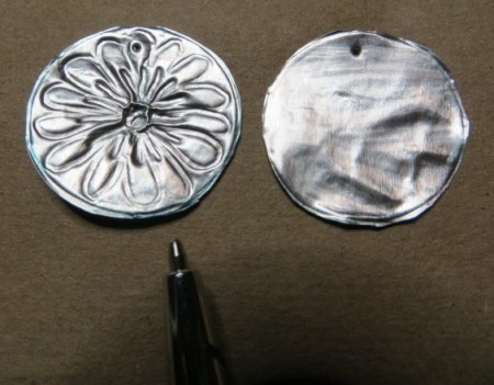 Etching the flower design onto the aluminum circle.