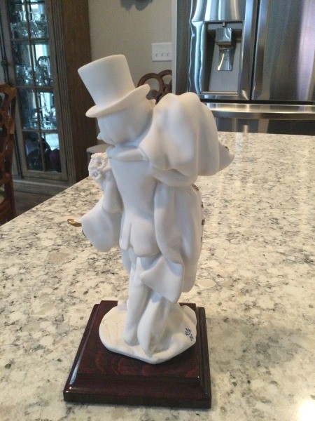 A figurine of two children getting married.
