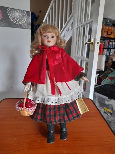 A porcelain doll of Little Red Riding Hood.