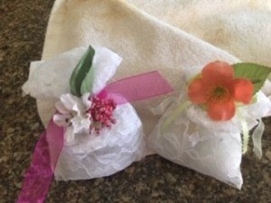 Two completed sachets with decorative flowers.