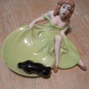 A figurine of a woman in a green dress.
