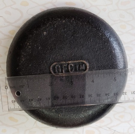 Identifying a Shallow Cast Iron Dish? - bottom with cast TM and ruler