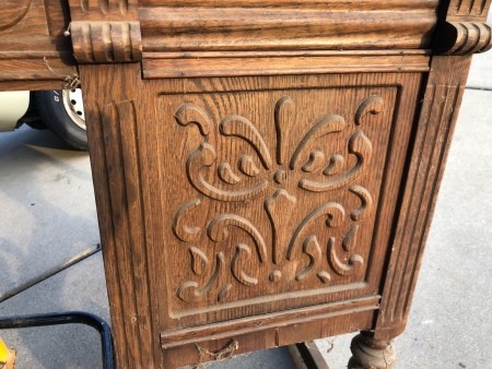 A carved panel on a wooden desk.
