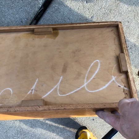 The bottom of a wooden desk.