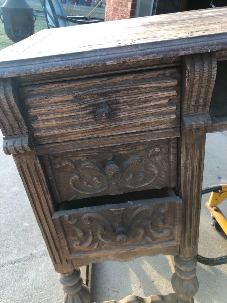 The drawers of a wooden desk.