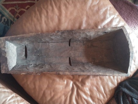 The back of a carved wooden mask.