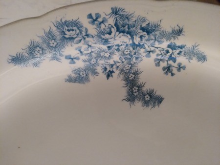 A close up of the flowers on a set of china.