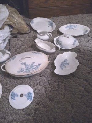 A set of white china with blue flowers.