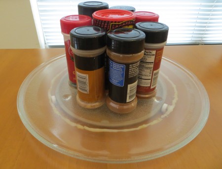 A microwave tray being used to hold spices.