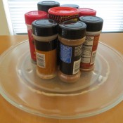 A microwave tray being used to hold spices.