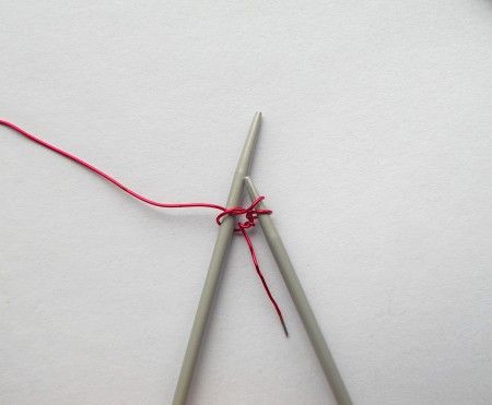 Using crochet hooks to knit the wire together.