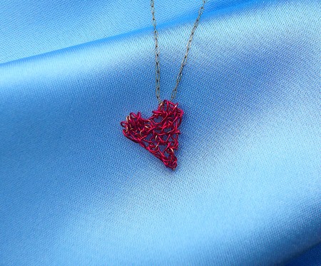 The pendant hanging on a chain.