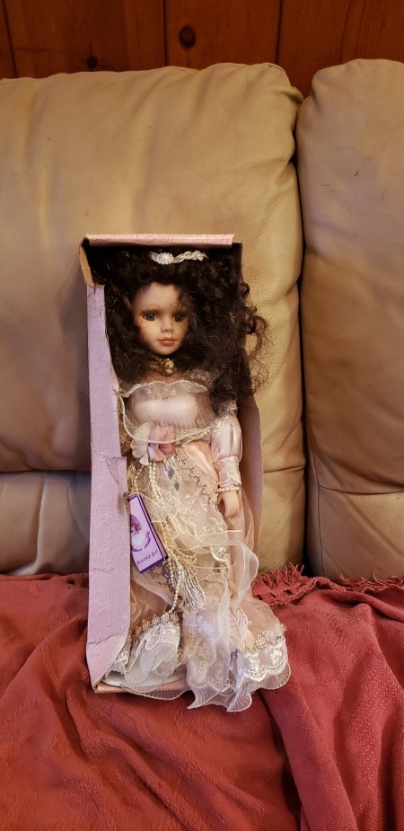 A porcelain doll in a box.