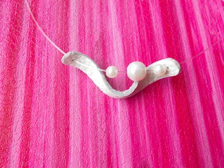 Attaching the beads to the leather.