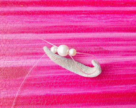 Attaching the beads to the leather.