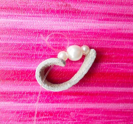 Attaching the beads to the leather.