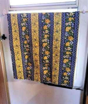 A window covered with colorful fabric.