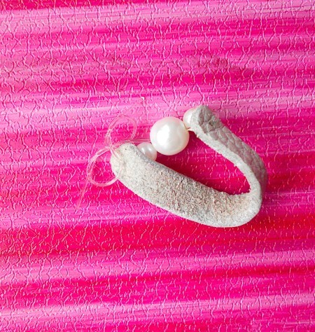 Attaching the beads to the leather.