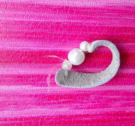 Attaching the beads to the leather.