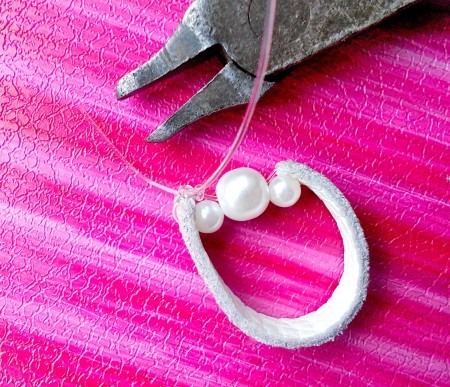 Attaching the beads to the leather.