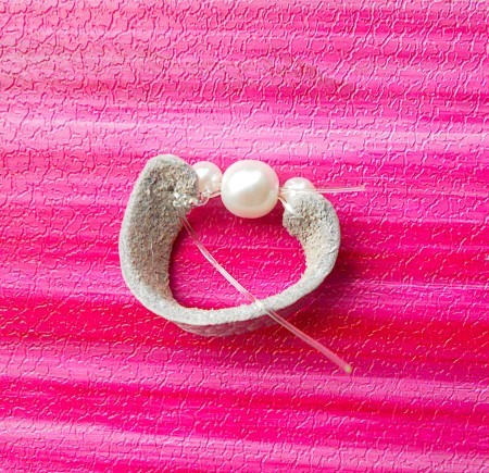 Attaching the beads to the leather.