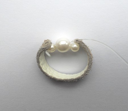 Finishing the leather beaded ring.