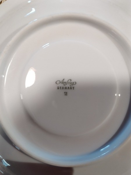 The marking on the back of a dish.