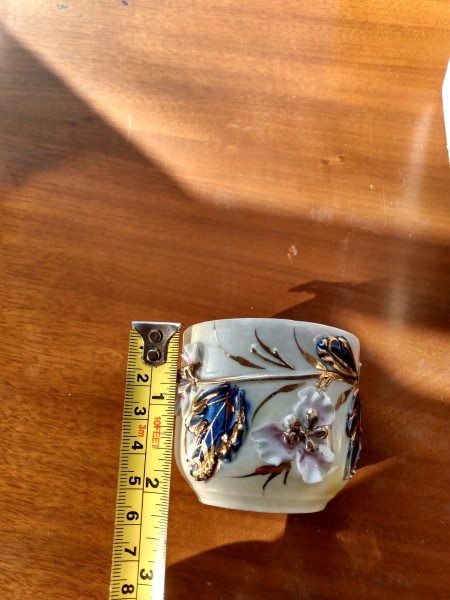 A decorative mug with flowers.