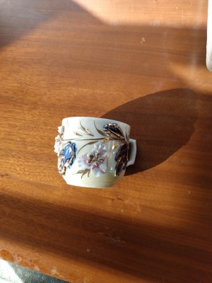 A decorative mug with flowers.