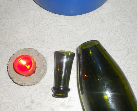 Glass bottle with the top cut off.