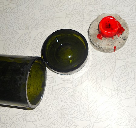Glass bottle with bottom cut off.