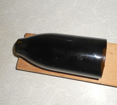 Glass bottle with top and bottom cut off.