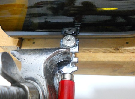 Vice holding glass cutting blade.