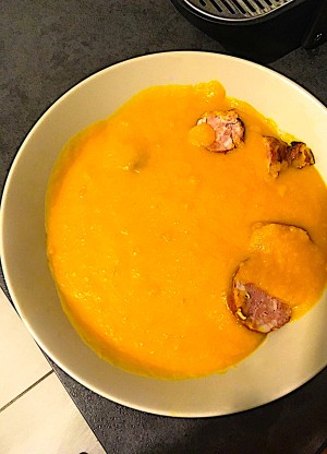The creamy soup with sausage pieces.