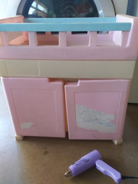 An old toy with a worn sticker on the front.