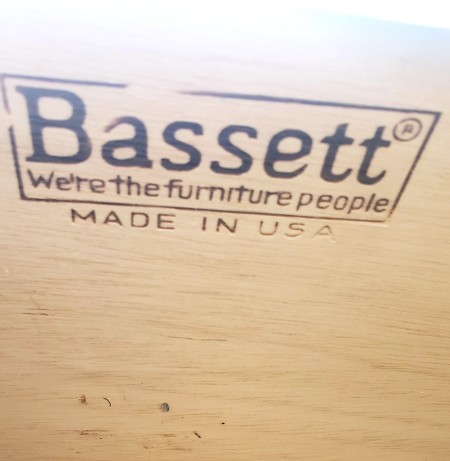 The Bassett marking on the back of a dresser.