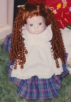 A doll with long red curly hair.