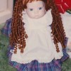A doll with long red curly hair.