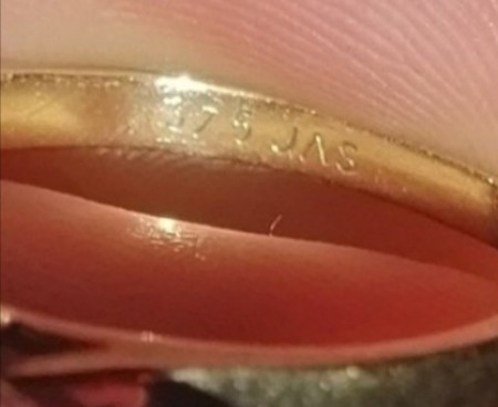A jeweler's mark inside a ring.