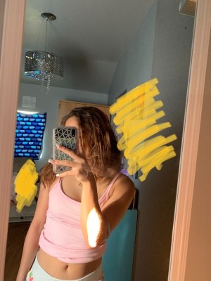 A woman taking a picture in a mirror.