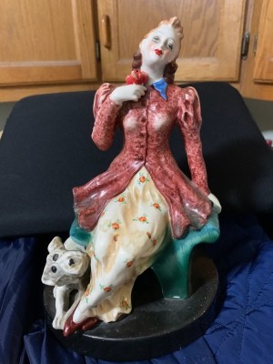A figurine of a woman and a dog.