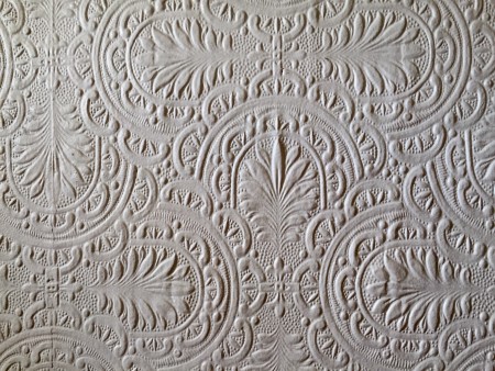 A white textured wallpaper.